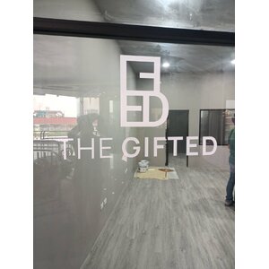 งานตัดสติกเกอร์ชื่อบริษัทและโลโก้ ติดลงบนกระจก งานTHE GIFTED