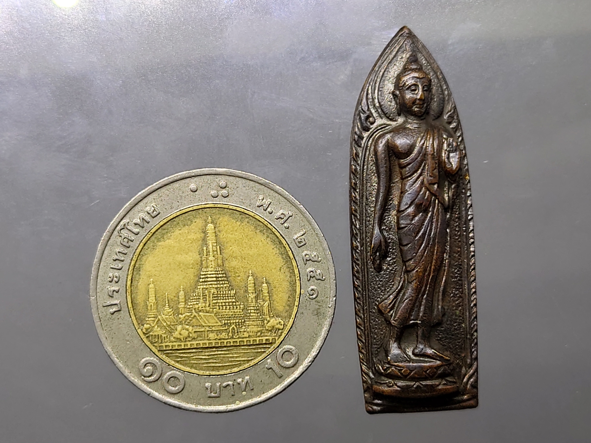เหรียญพระพุทธนวฤทธิ์ (ปางลีลา) จิตตภาวันวิทยาลัย จ.ชลบุรี เนื้อทองแดงรมดำ ปี 2512