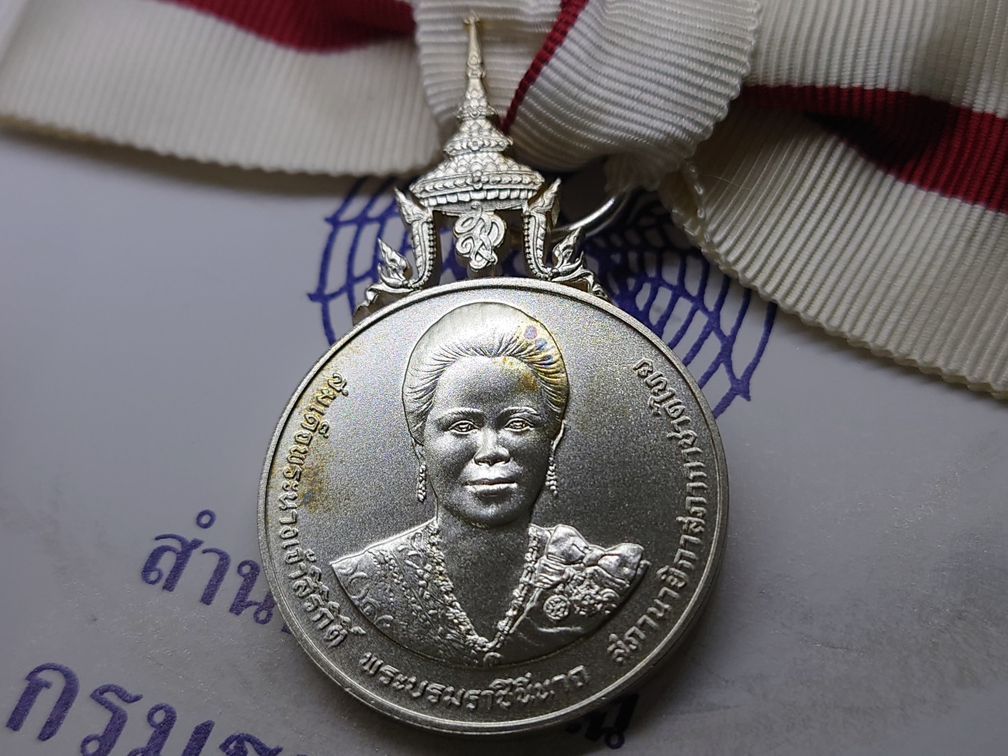 เหรียญเงินประดับแพรแถบ กาชาดสดุดีพระบรมราชินีนาถ สภานายิกาสภากาชาดไทย แบบหญิง