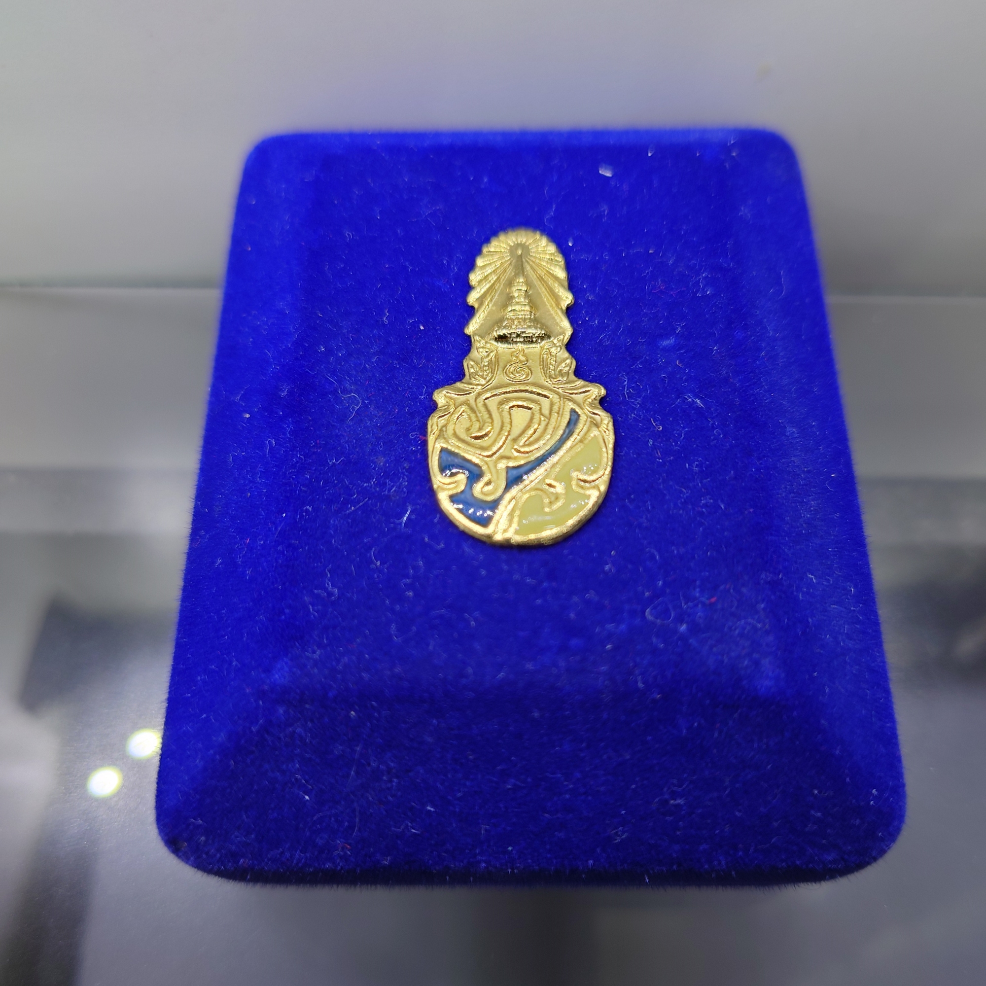 พระพุทธสิงหธรรมมงคล หลังพระปรมาภิไธย ภ.ป.ร.เนื้อนวะ พุทธสมาคมแห่งประเทศไทย ในพระบรมราชูปถัมภ์ พ.ศ.2547 เลี่ยมกรอบทองนพเก้า พร้อมตลับเดิม
