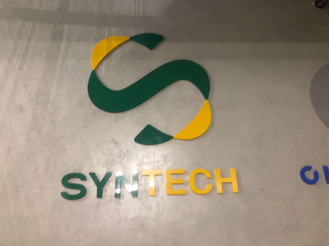 ป้ายชื่อบริษัทและโลโก้ เลเซอร์ฉลุอะคริลิคพ่นสีตามโลโก้ งานSYNTECH SYNHUB CLINITECH
